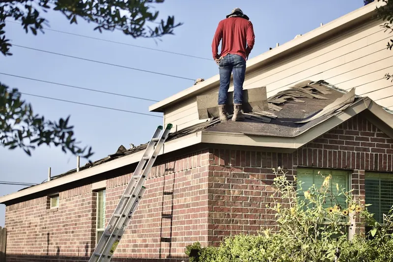 Professional roofer working on a residential roof in Whiteford